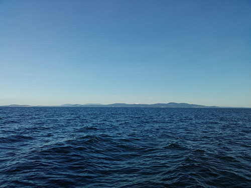 Looking across Haro Strait, past Zero Rock at San Juan Island with Mount Baker peaking out.