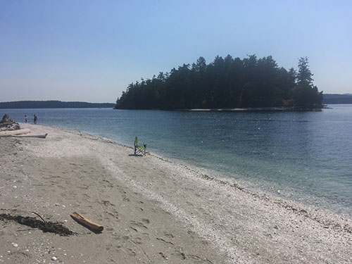 Beating the heat with my chair in the surf at Shell Beach.
