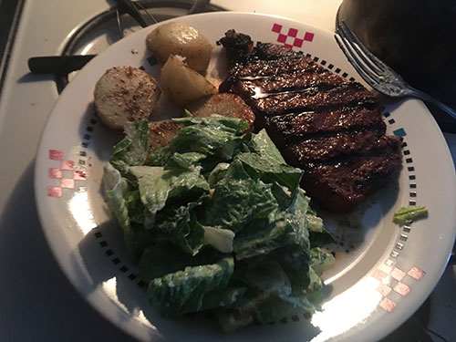  Bar-B-Que strip loin, roasted potatoes and caesar salad for dinner.