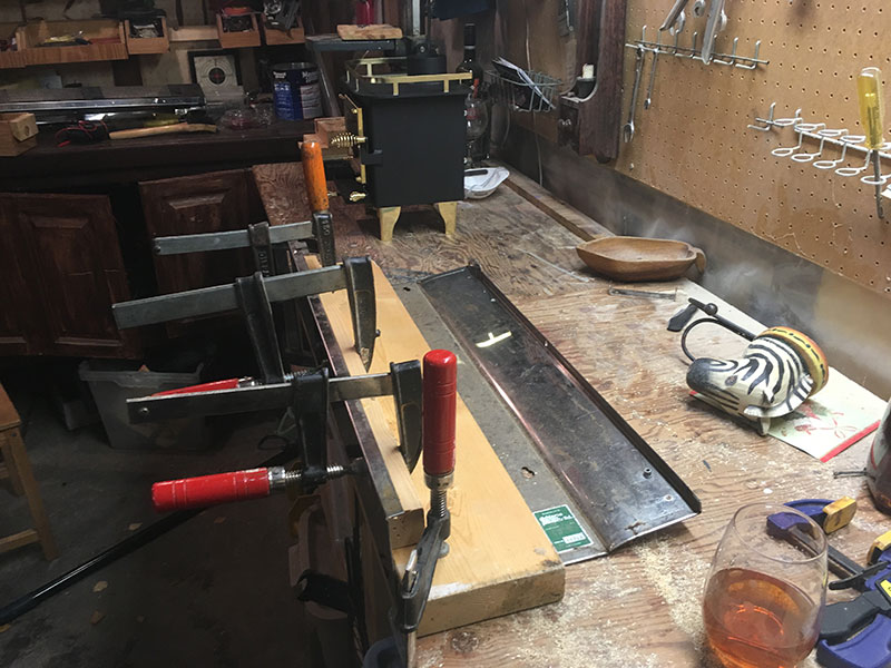 Straitening the original heat shield from the ol' Chesapeake.