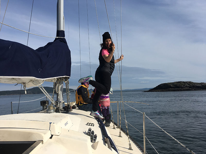 Tania plays while Mario fishes in Princess Bay, Portland Island.