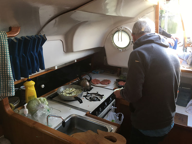 Chef Paul in the galley preparing the hamburgers for dinner at Prevost Island.
