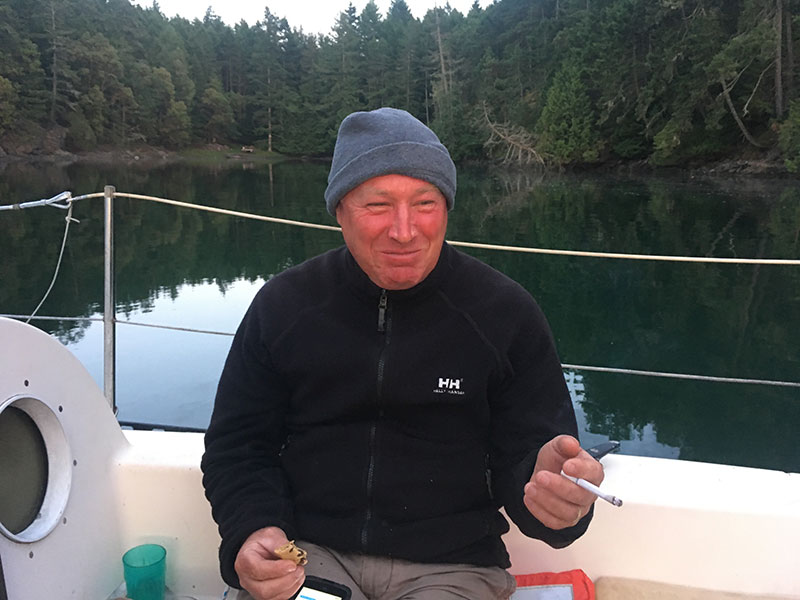 Kevin enjoys a smoke while relaxing at anchor in Glenthorne Passage, Prevost Island.