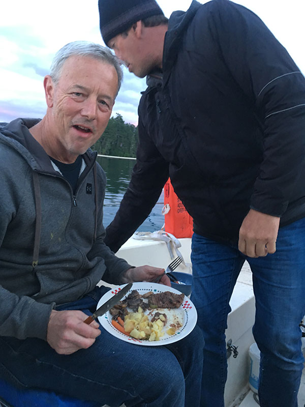 Paul enjoys his steak dinner at Princess Bay, Portland Island.