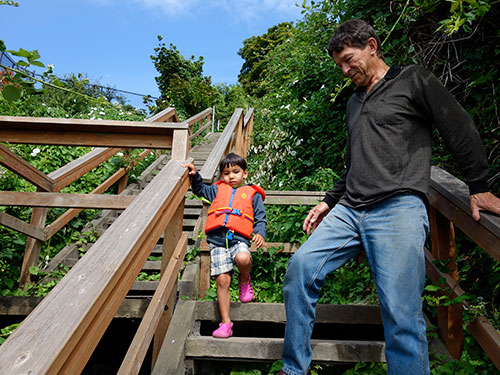 Barnucka guides Rio down the 72 steps to the beach.