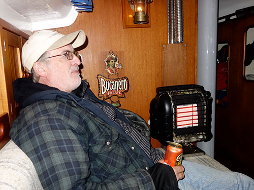 Tom enjoys a well deserved beer while relaxing by the heater.