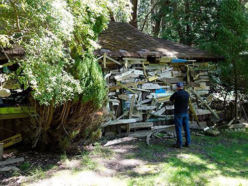 One of the cabins at Conover Cove. This one is covered inside and out with boat signs carved out of driftwood.