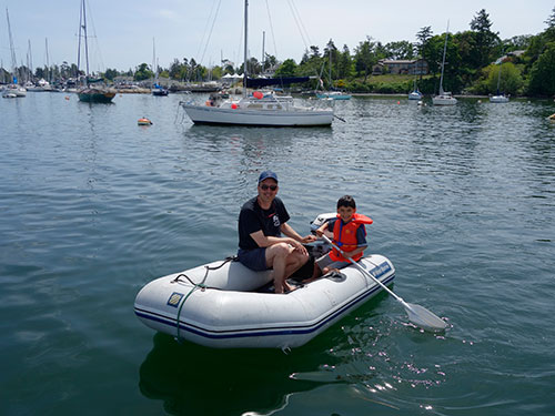 Rio enjoys rowing in the dinghy.