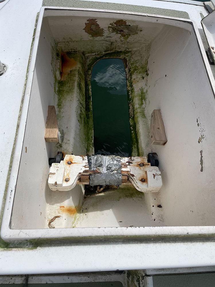 Port lazarette. This is where the outboard goes. You can swing it up and clear of the water and best of all, it doesn't hang off the stern of your boat.